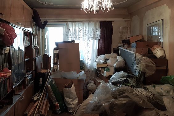 Apartment of compulsive hoarder, littered with trash and books