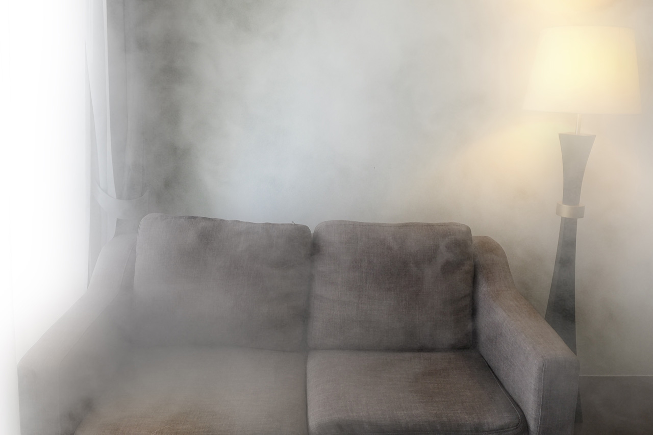 Sofa and lamp in smoke filled room